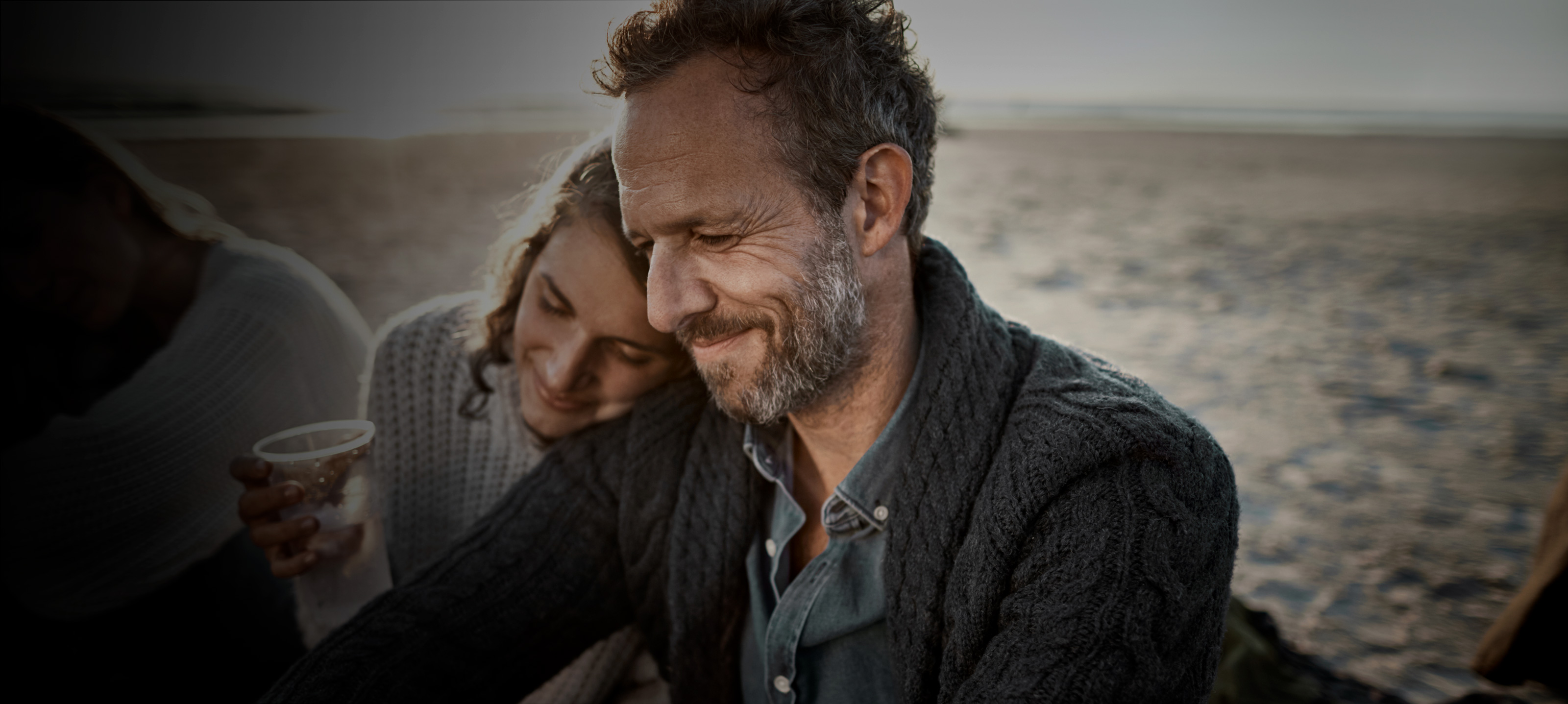 Couple enjoying drink on the beach
